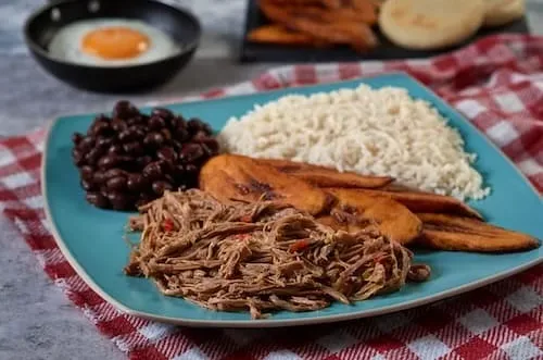 pabellon-criollo-with-eggs-typical-venezuelan-colombian-food-with-shredded-meat-rice-beans (1)